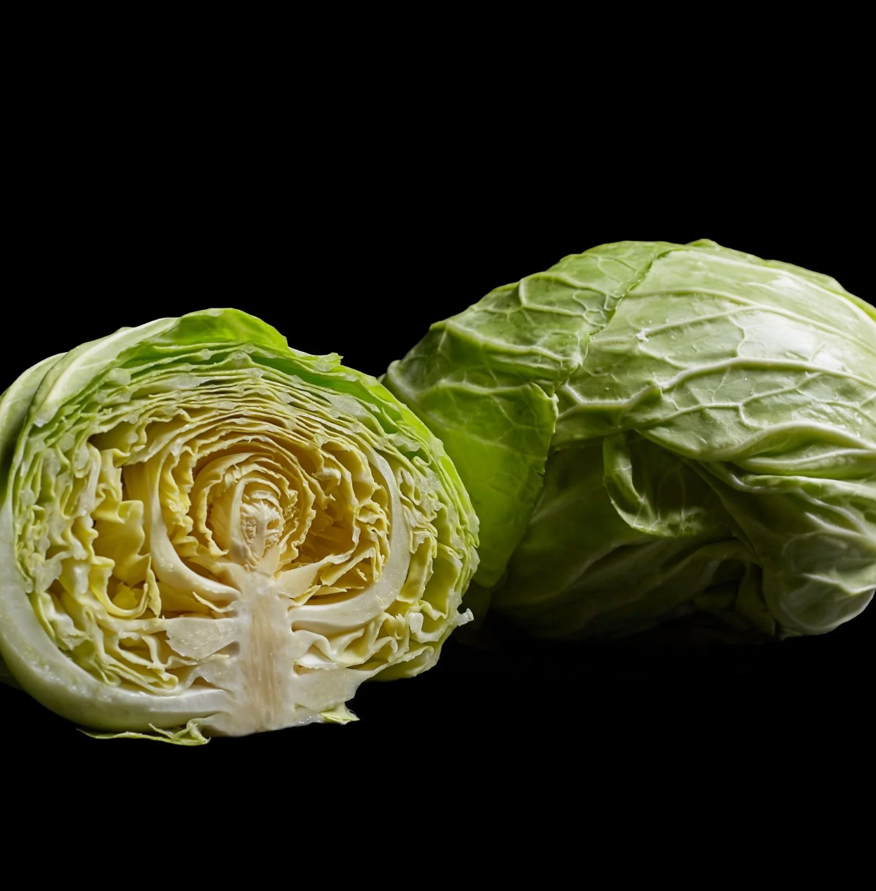 Saku Saku cabbage, whole and cut to show its crisp layered interior, included in the Asian vegetable box.