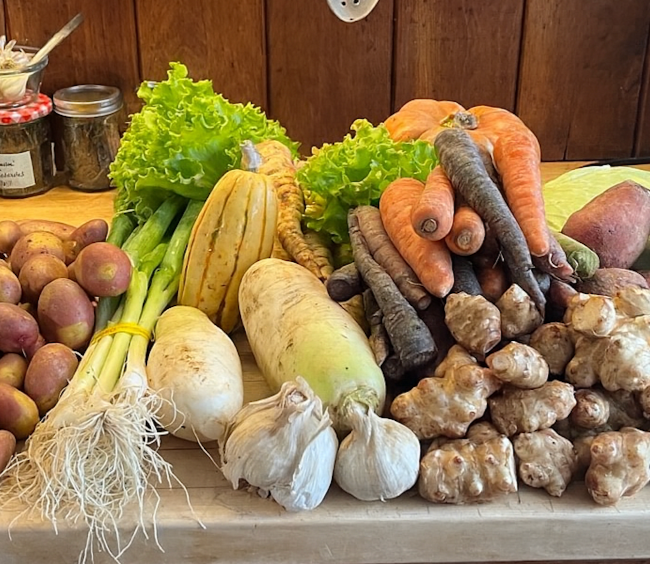 Example of a weekly CSA share featuring leafy greens, roots, herbs, and seasonal produce.