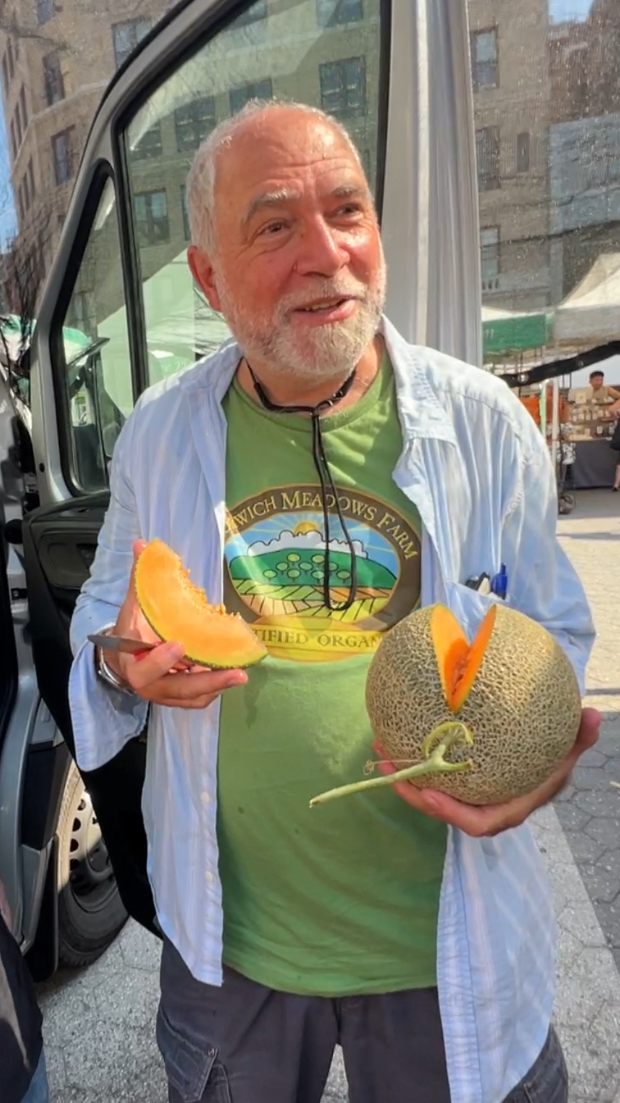 Zaid from Norwich Meadows Farm enjoying a Hokkaido Melon.