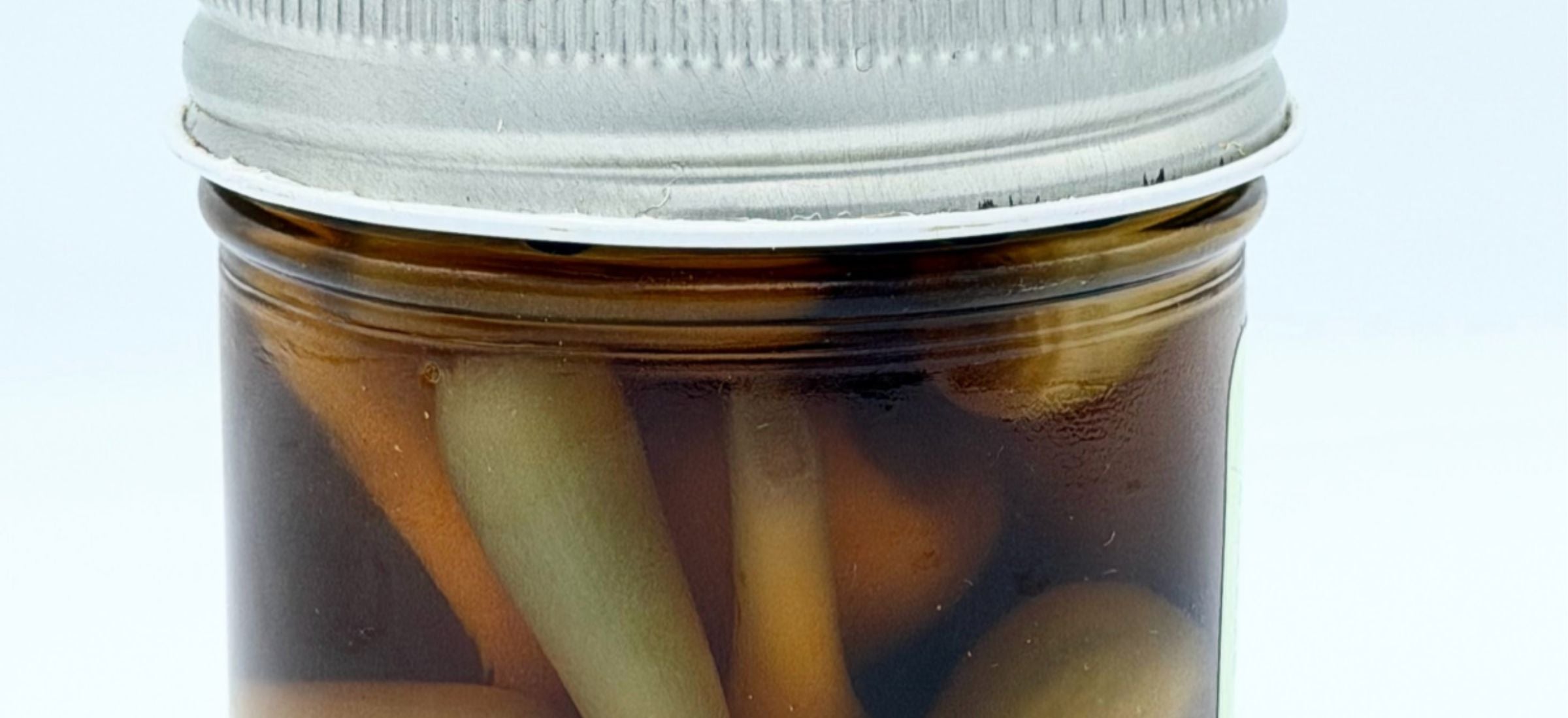 Small-batch pantry items from Norwich Meadows Farm, including jars of pickles and preserved vegetables like ramps.